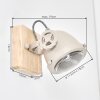 Zandkleurige wandlamp Herford met tandwielachtige verstelring als leeslicht naast het bed
